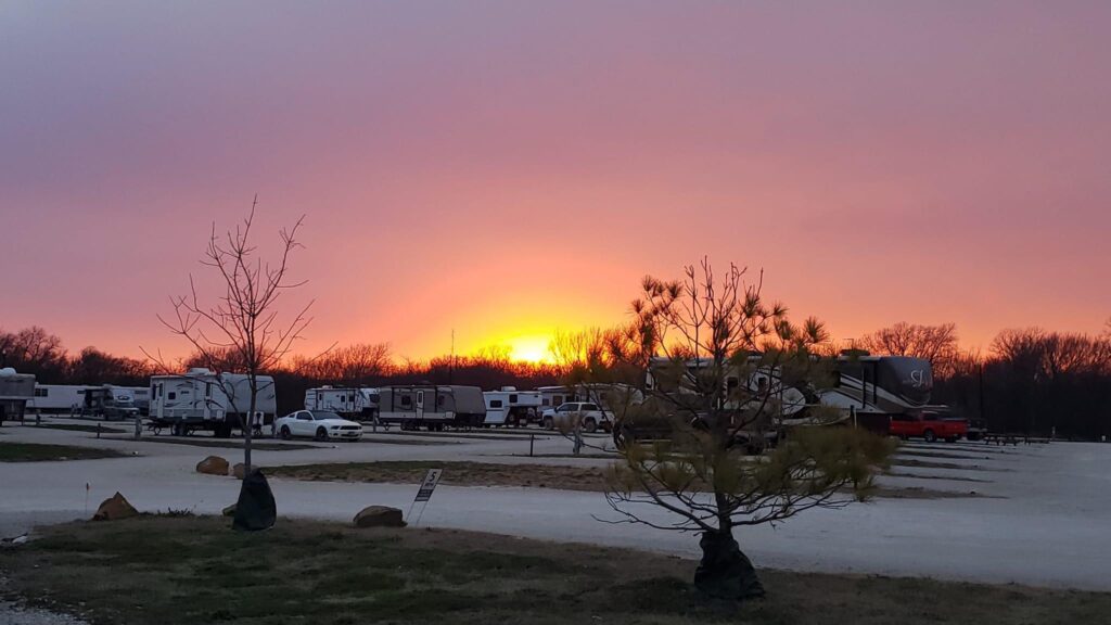 Sunset view of full hookup RV sites at Lake Point RV Resort in Valley View Texas